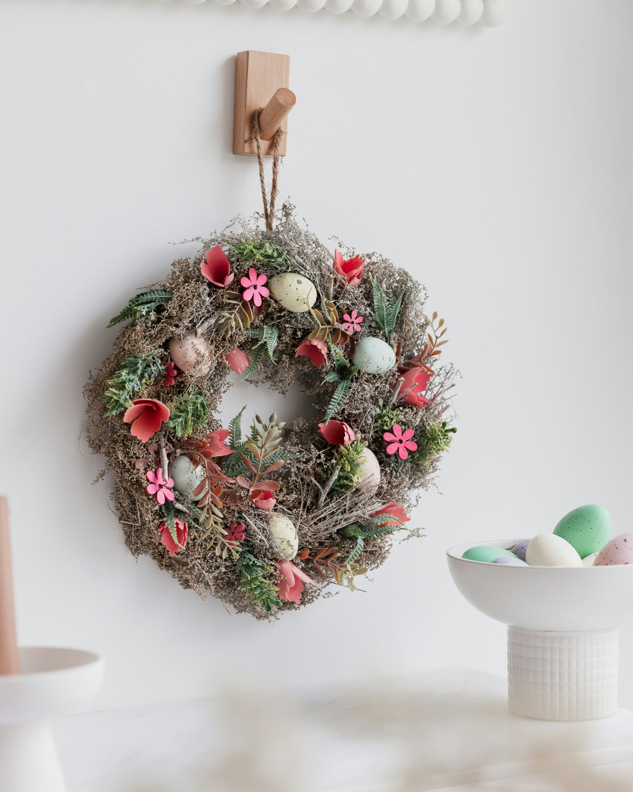 https://unsplash.com/photos/a-wreath-hanging-on-a-wall-next-to-a-bowl-of-eggs-uvhe1V5fgLE?utm_content=creditShareLink&utm_medium=referral&utm_source=unsplash